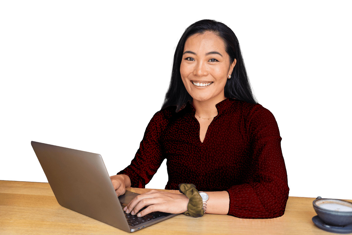 Smiling woman using laptop at desk